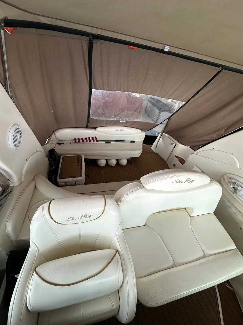 Slide: The Image of Interior of a 1999 Sea Ray 340 Sundancer yacht with white seating. - 13