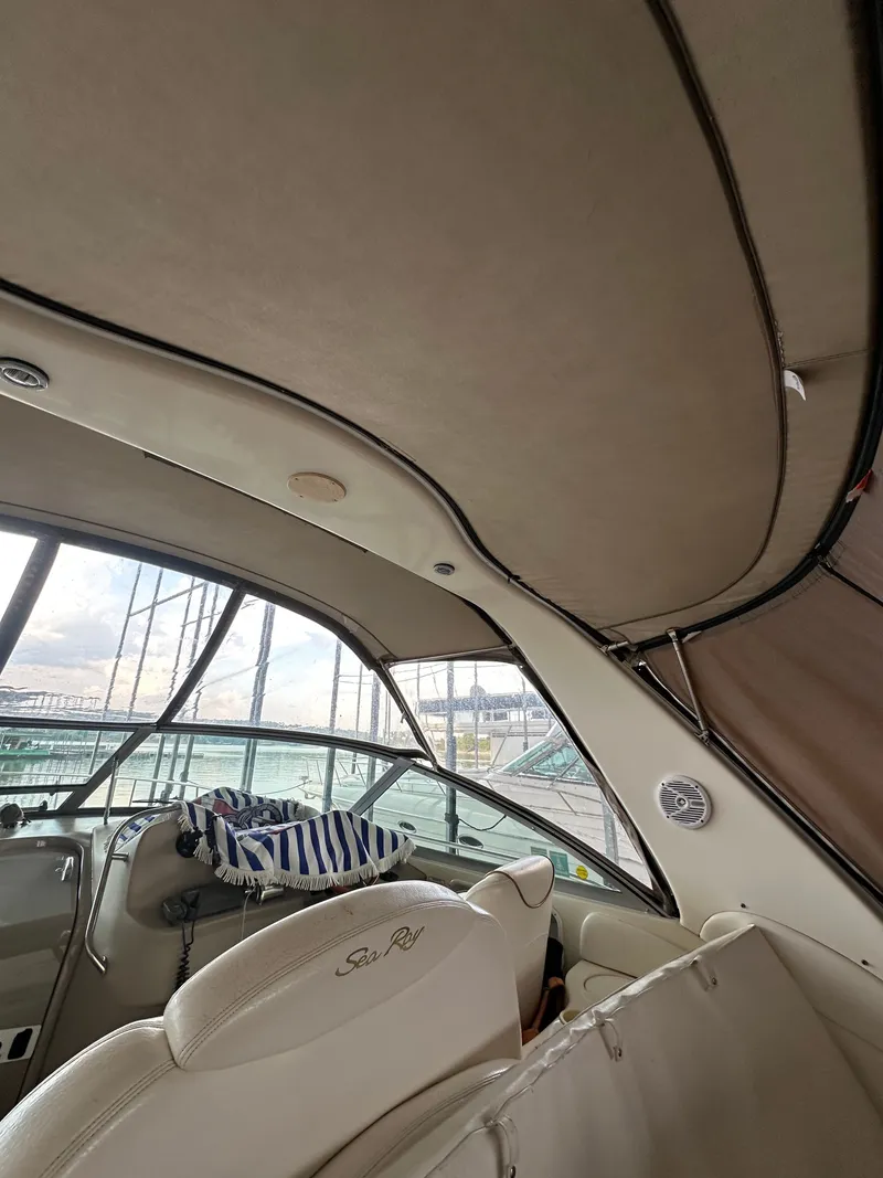 Slide: The Image of Interior of a 1999 Sea Ray 340 Sundancer yacht with cushioned seating. - 16