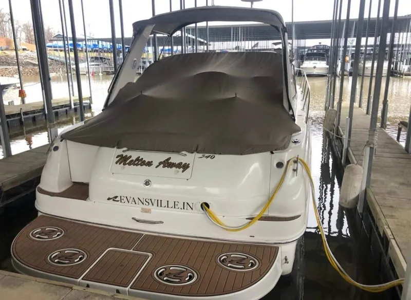 Slide: The Image of 1999 Sea Ray 340 Sundancer docked and covered at marina. - 17