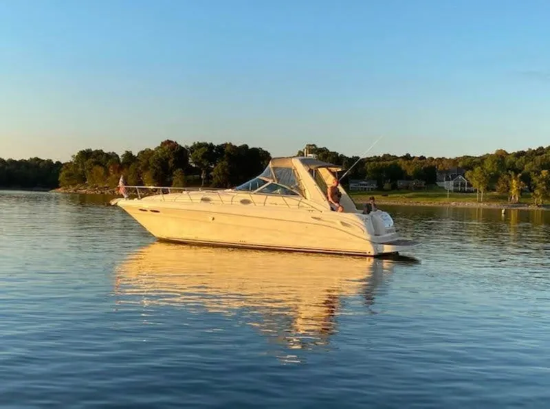 Slide: The Image of 1999 Sea Ray 340 Sundancer on calm water at sunset. - 18