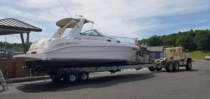 Slide: The Image of 1999 Sea Ray 340 Sundancer being transported on a trailer. - 23
