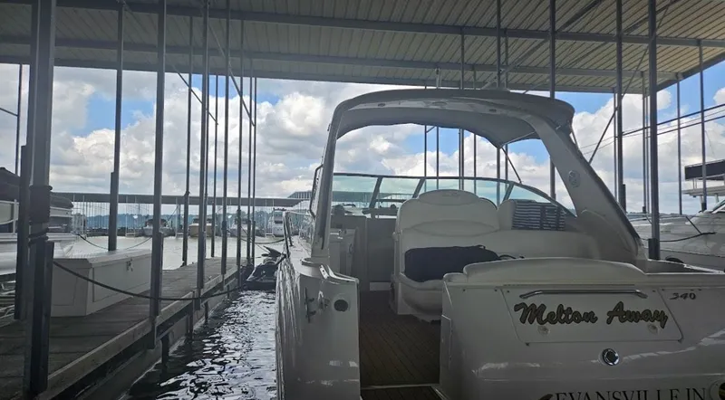 Slide: The Image of 1999 Sea Ray 340 Sundancer docked in a covered marina. - 25