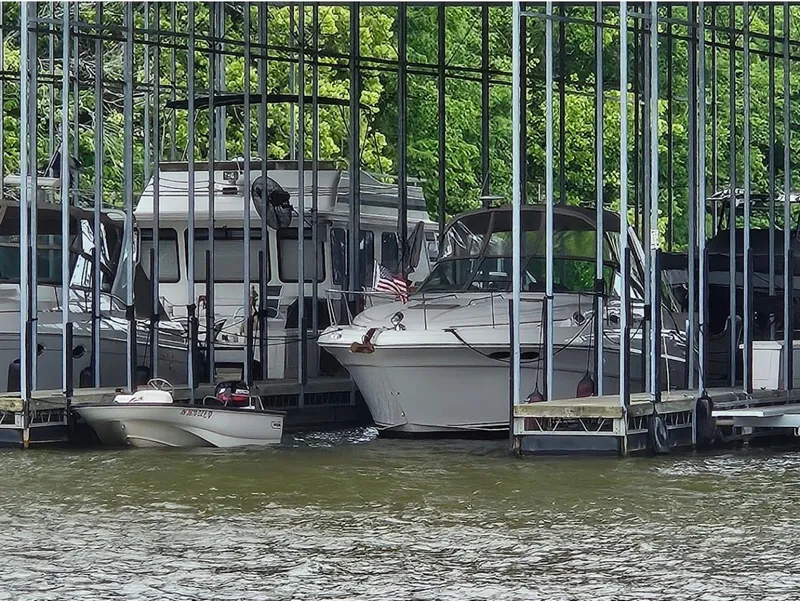 Slide: The Image of 1999 Sea Ray 340 Sundancer docked, surrounded by boats. - 26