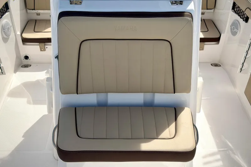 Slide: The Image of 2025 Yamaha Boats 222 FSH Sport interior seating, featuring beige cushioned seats. - 21