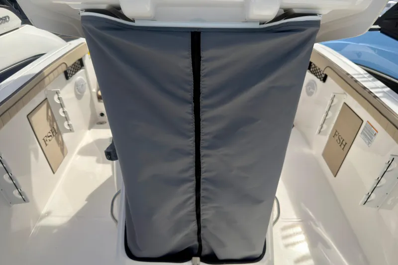 Slide: The Image of 2025 Yamaha Boats 222 FSH Sport interior with protective cover and storage compartments. - 22