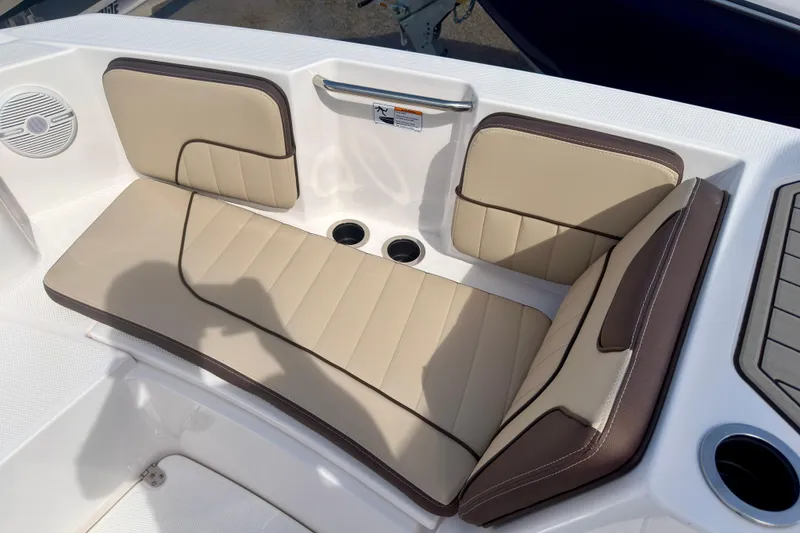 Slide: The Image of 2025 Yamaha Boats 222 FSH Sport interior seating with beige and brown cushions. - 23