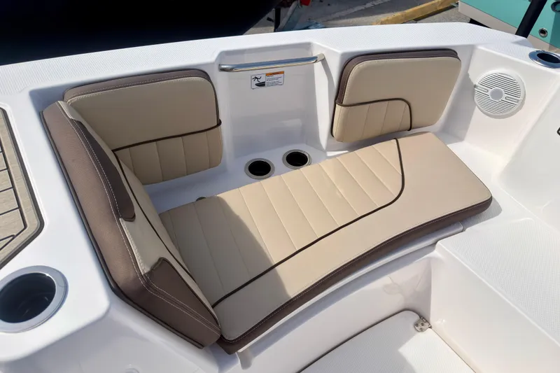 Slide: The Image of 2025 Yamaha Boats 222 FSH Sport interior seating with beige and brown cushions. - 24
