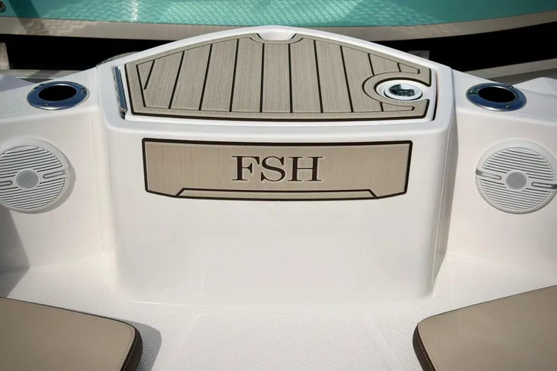Slide: The Image of 2025 Yamaha Boats 222 FSH Sport interior detail with speakers and storage compartment. - 25