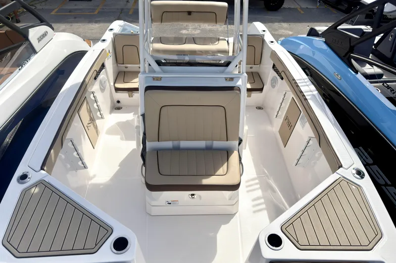 Slide: The Image of 2025 Yamaha Boats 222 FSH Sport interior with beige seating and spacious deck layout. - 27