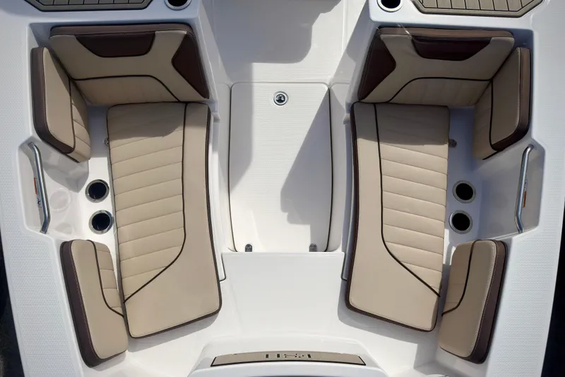 Slide: The Image of 2025 Yamaha Boats 222 FSH Sport interior seating, featuring beige and brown cushioned seats. - 28