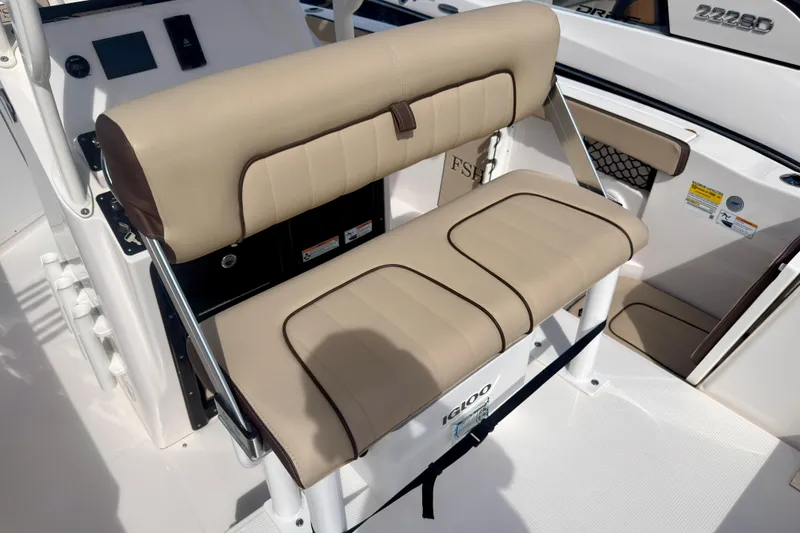 Slide: The Image of 2025 Yamaha Boats 222 FSH Sport interior seating with beige upholstery and Igloo cooler. - 30