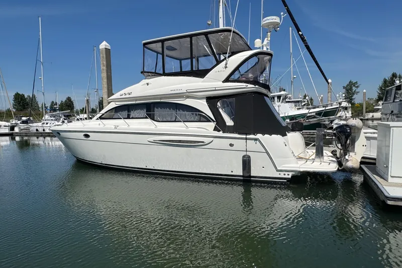 The Image of 2007 Meridian 411 Sedan yacht docked in a marina under clear blue skies. - 0
