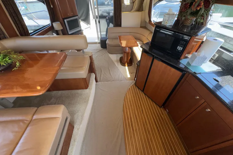 Slide: The Image of Luxurious interior of a 2007 Meridian 411 Sedan yacht with elegant seating and kitchenette. - 10