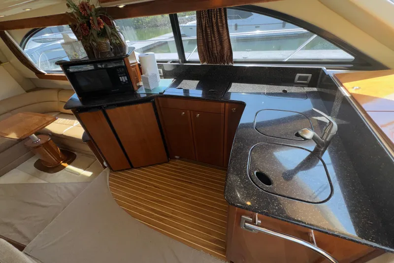 Slide: The Image of Luxurious 2007 Meridian 411 Sedan yacht interior with modern kitchen and elegant wood finishes. - 11