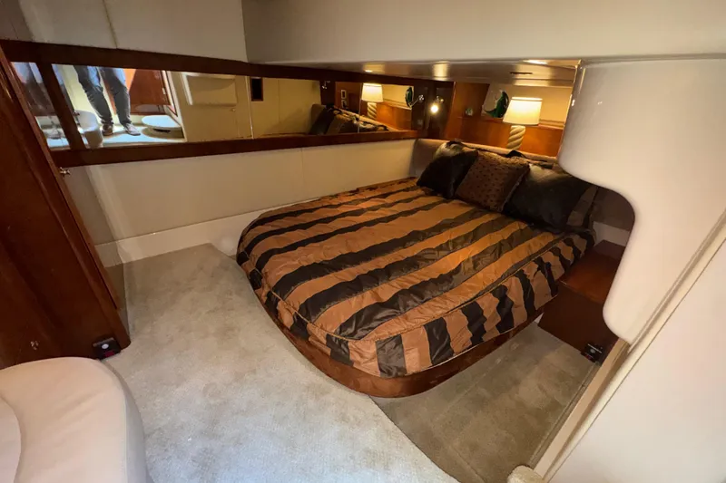 Slide: The Image of Luxurious bedroom interior of 2007 Meridian 411 Sedan yacht with striped bedding. - 12