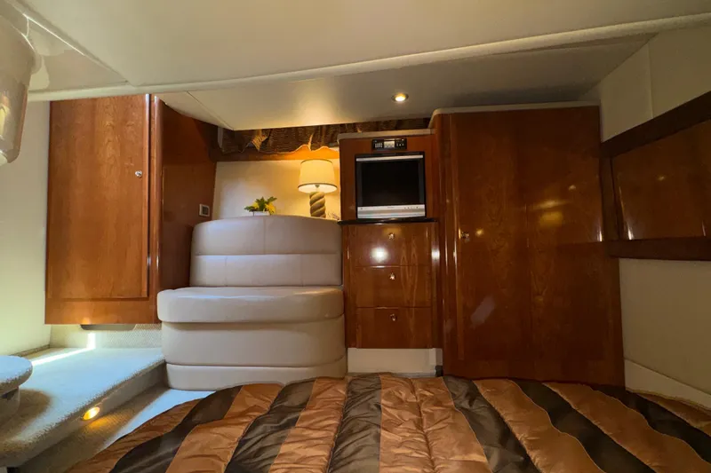 Slide: The Image of Luxurious interior of a 2007 Meridian 411 Sedan yacht with wood paneling and cozy seating. - 15