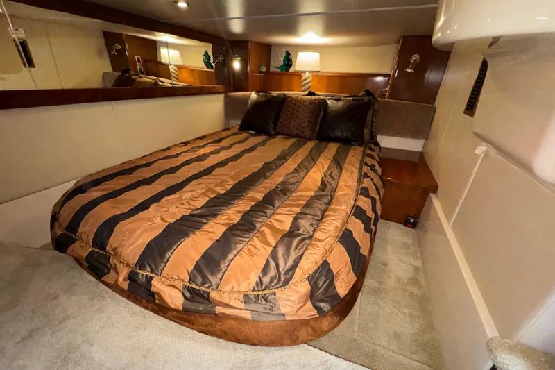 Slide: The Image of Luxurious bedroom interior of 2007 Meridian 411 Sedan yacht with striped bedding. - 16