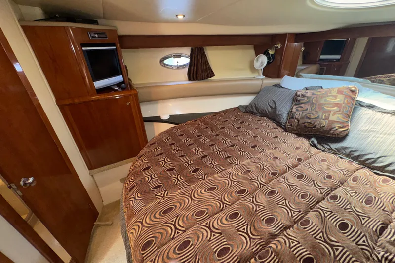 Slide: The Image of Luxurious bedroom interior of 2007 Meridian 411 Sedan yacht with patterned bedding. - 17