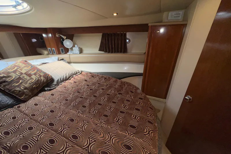Slide: The Image of Luxurious bedroom interior of 2007 Meridian 411 Sedan yacht with patterned bedding and wood accents. - 18