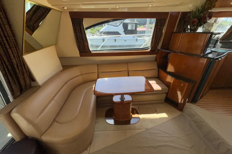 Slide: The Image of Luxurious interior of a 2007 Meridian 411 Sedan yacht with elegant seating and wooden accents. - 2