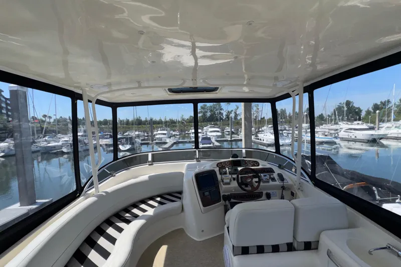 Slide: The Image of Interior view of 2007 Meridian 411 Sedan yacht at marina, showcasing helm and seating area. - 27