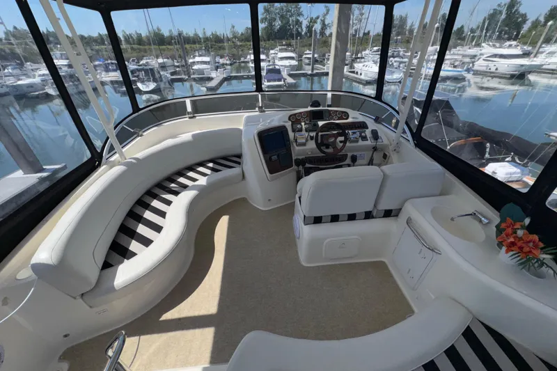 Slide: The Image of Interior of 2007 Meridian 411 Sedan yacht with helm, seating, and marina view. - 28