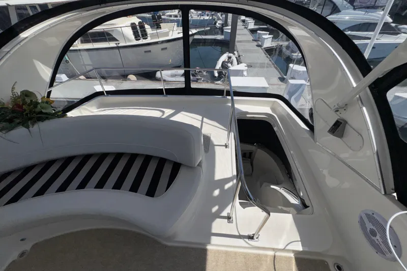 Slide: The Image of Interior view of 2007 Meridian 411 Sedan yacht with seating and marina backdrop. - 29