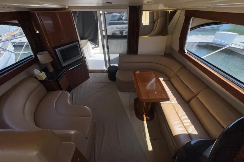 Slide: The Image of Luxurious interior of a 2007 Meridian 411 Sedan yacht with leather seating and a wooden table. - 3
