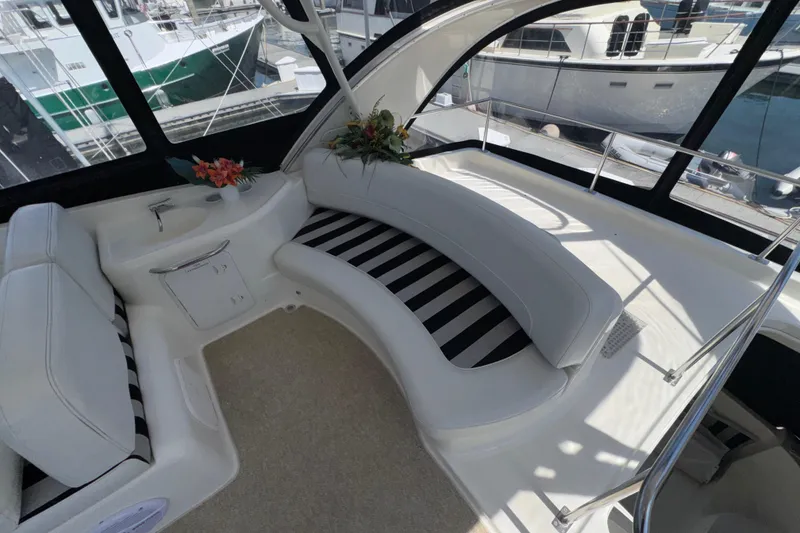 Slide: The Image of Luxurious 2007 Meridian 411 Sedan yacht interior with striped seating and floral decor. - 30
