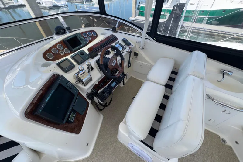 Slide: The Image of Cockpit of 2007 Meridian 411 Sedan with modern navigation equipment and white seating. - 31