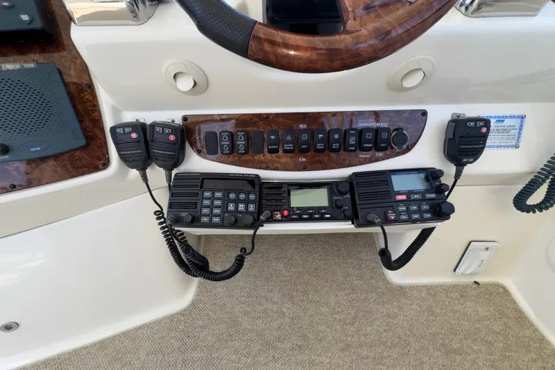 Slide: The Image of Control panel of a 2007 Meridian 411 Sedan with communication radios and switches. - 32