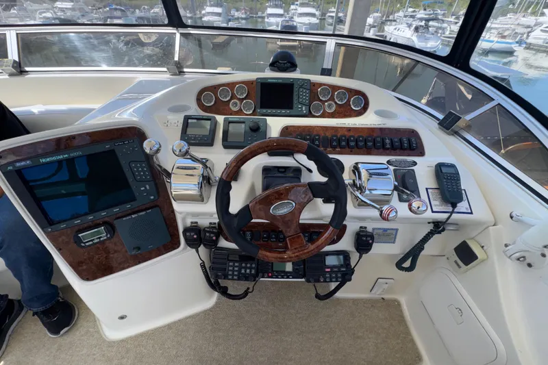 Slide: The Image of Cockpit of 2007 Meridian 411 Sedan with steering wheel, navigation controls, and marine electronics. - 33