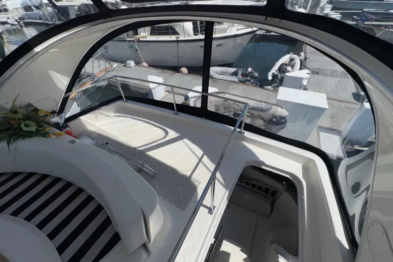 Slide: The Image of Interior view of 2007 Meridian 411 Sedan yacht with elegant seating and marina backdrop. - 34