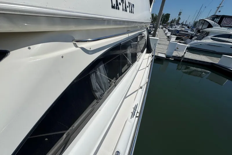 Slide: The Image of 2007 Meridian 411 Sedan yacht docked at marina, side view with water reflection. - 44
