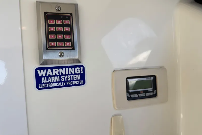 Slide: The Image of Keypad and alarm system on 2007 Meridian 411 Sedan, featuring electronic protection warning. - 47