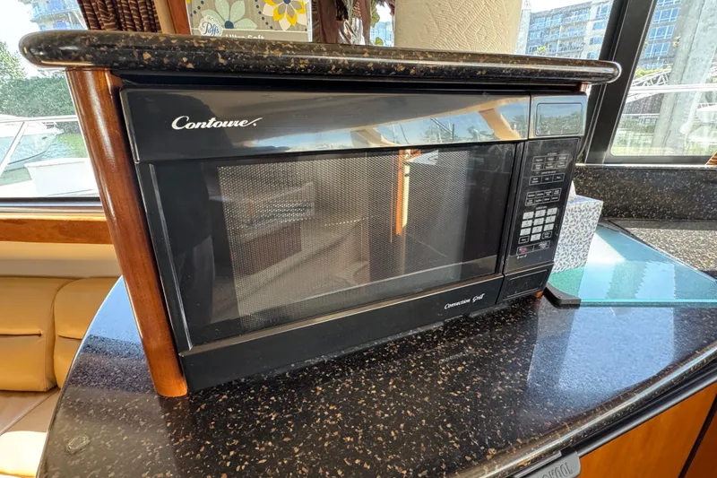 Slide: The Image of Microwave on granite countertop inside 2007 Meridian 411 Sedan yacht kitchen. - 60