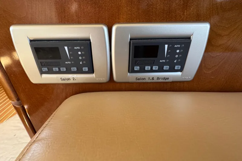 Slide: The Image of Control panels in a 2007 Meridian 411 Sedan yacht interior, labeled for salon and bridge. - 61