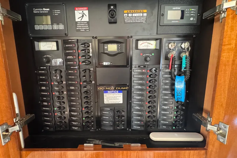 Slide: The Image of Electrical control panel inside a 2007 Meridian 411 Sedan boat, featuring various switches and meters. - 62