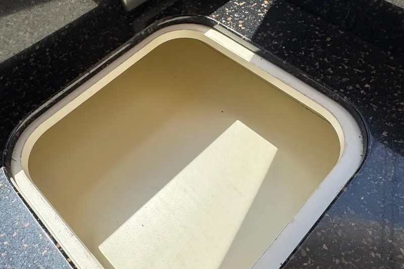 Slide: The Image of Granite countertop with built-in outlet and recessed compartment on a 2007 Meridian 411 Sedan. - 63