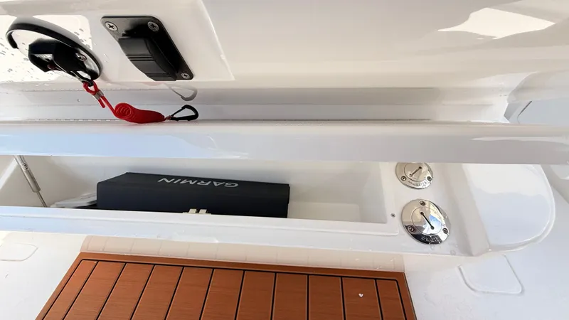 Slide: The Image of Valhalla Boatworks V33 2026, storage compartment with Garmin equipment. - 15