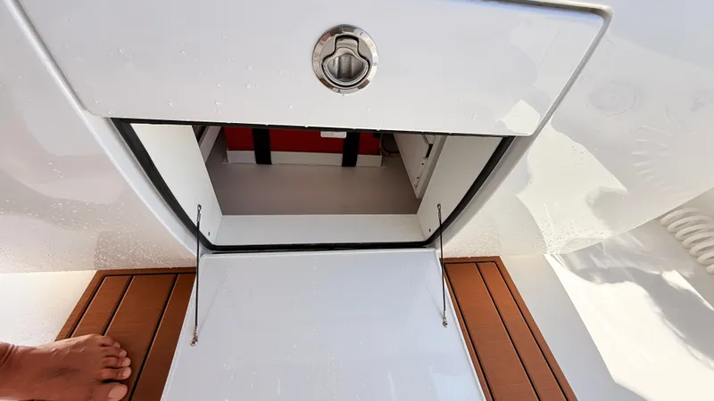 Slide: The Image of Valhalla Boatworks V33 2026 storage compartment with wooden deck. - 16