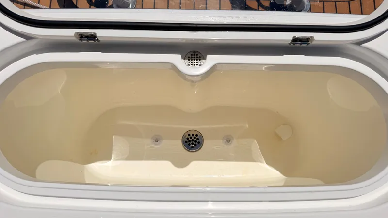 Slide: The Image of Valhalla Boatworks V33 2026 livewell with drain and lid. - 33