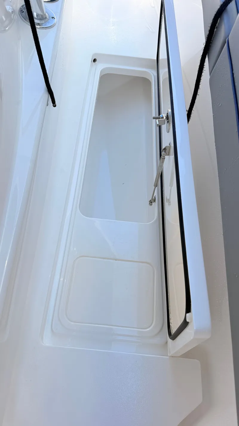 Slide: The Image of Open storage compartment on a 2026 Valhalla Boatworks V33 boat. - 34