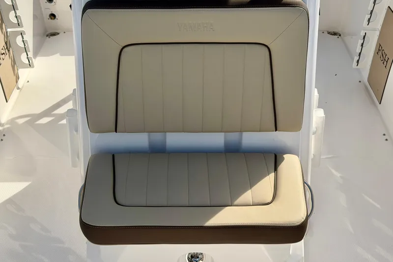Slide: The Image of 2026 Yamaha Boats 255 FSH Sport H seat, beige and brown upholstery, sleek design. - 24