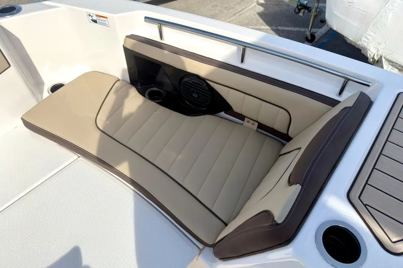 Slide: The Image of Luxurious seating on 2026 Yamaha Boats 255 FSH Sport H, featuring beige upholstery and cup holders. - 28