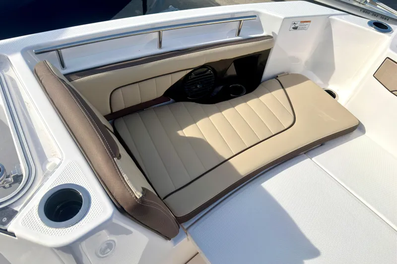 Slide: The Image of 2026 Yamaha Boats 255 FSH Sport H interior seating with beige upholstery and cup holders. - 29