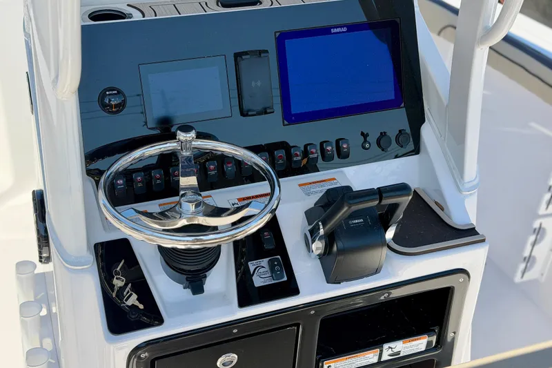 Slide: The Image of 2026 Yamaha Boats 255 FSH Sport H, rear view, showcasing seating and design features. - 3