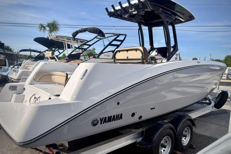 Slide: The Image of 2026 Yamaha Boats 255 FSH Sport H on trailer, sleek design, outdoor display. - 36