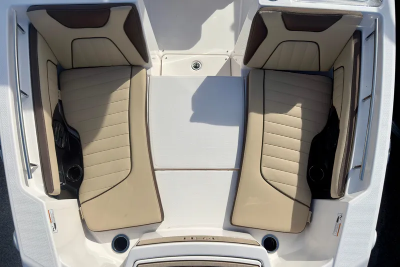 Slide: The Image of 2026 Yamaha Boats 255 FSH Sport H interior seating, featuring beige and brown cushioned seats. - 37