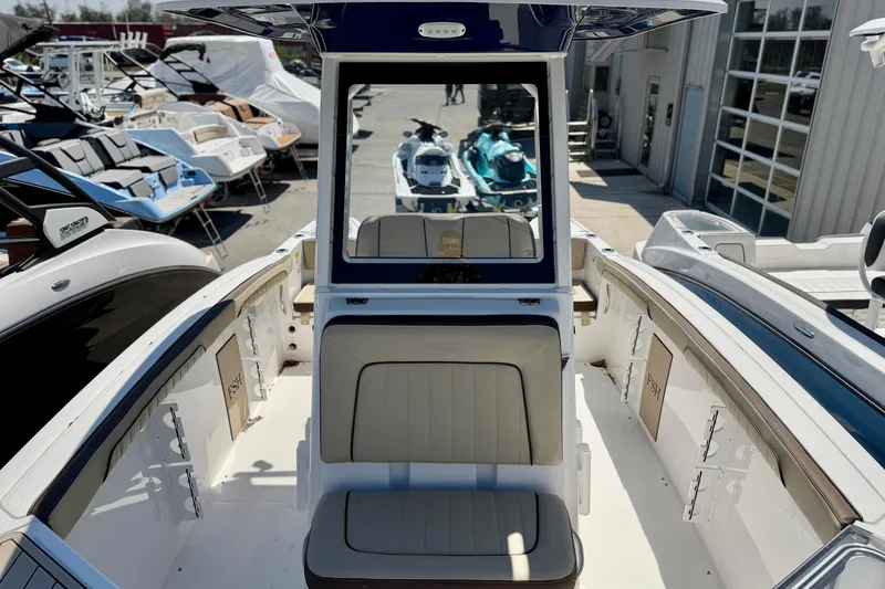 Slide: The Image of 2026 Yamaha Boats 255 FSH Sport H, center console view, sunny day. - 6
